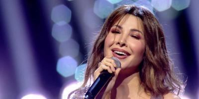 نانسي عجرم تثير حيرة الجمهور بالشعر الكيرلي ولون بشرتها..