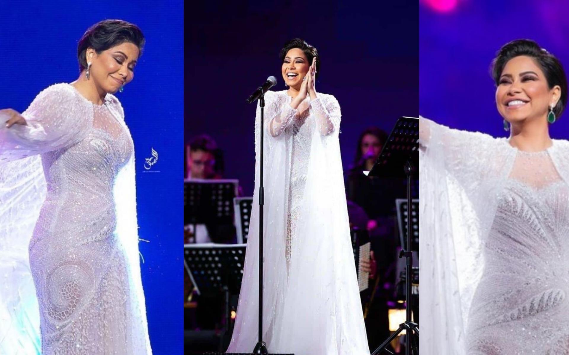 فستان أبيض بدت في كالعروس مع تصميم على شكل "كاب"